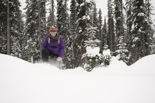 Woman Snowshoeing In Winter