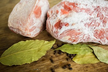 Frozen meat on a wooden table