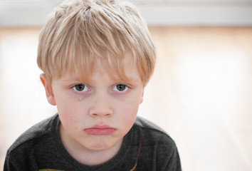 Boy with tear on cheek