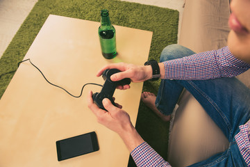 Close up photo of man playing video games with beer © deagreez