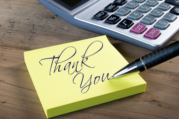 Yellow sticky note with "Thank you" written with pen.
Administrative Professionals or Secretaries day concept.