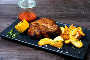 Pork steak with potatoes and vegetables