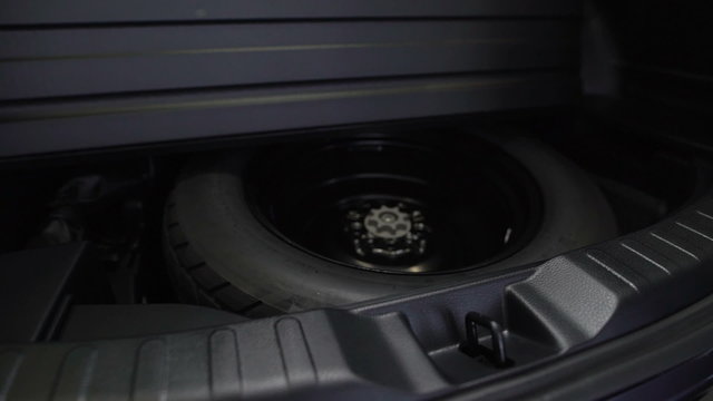 Spare tire in the trunk of a modern car. 