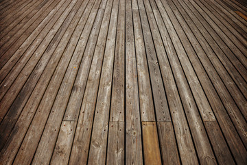 Part of old wooden pier made from planks.