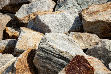 Closeup of huge rocks dam sea coastline port.