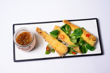 fried mozzarella sticks tomato sauce served with greens