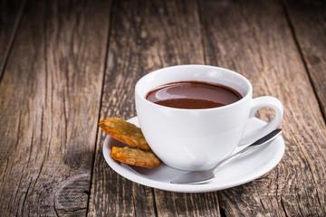 White cup of hot chocolate with homemade oat cookies.