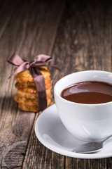 Hot chocolate with homemade oat cookies in satin ribbon.