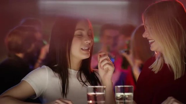 Girls chat at the bar