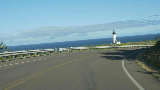 Driving point of view on a road leading to Yaquina Head Lighthouse, Newport, Oregon; Panasonic GH4.