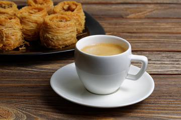 Cup of coffee and eastern sweets on blurred backgrpund