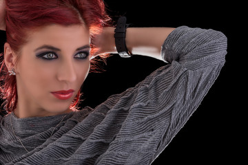 Horizontal shot of fashionable woman with smart watch on her left hand looking further, shot on black background with copy space