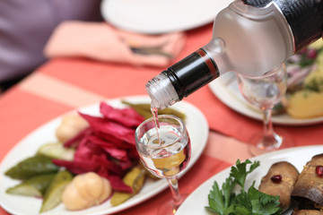 Person pouring vodka