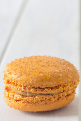 Salted Caramel Macaron on White Table Close Up Vertical