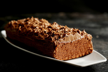 Chocolate cake on a black wooden background