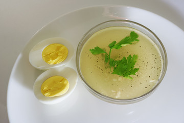 bowl of broth with egg and parsley