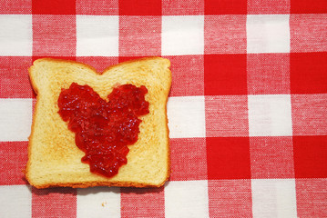 Jelly spread in a heart shape on a piece of toast