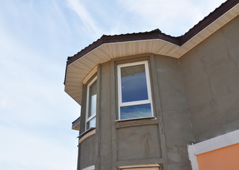 Painting and Plastering Exterior House Tower Wall. Facade Thermal Insulation and Painting Works During Exterior Renovations with Sofits.