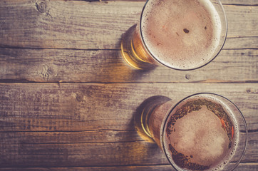 Overhead shot of beer glasses on an old wooden table