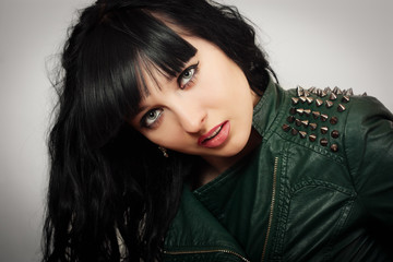 Portrait of a woman in a leather jacket with spikes