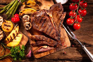 Beef steak with grilled vegetables on wood