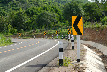 road signs warn for ahead dangerous curve