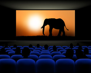 Obraz premium Cinema hall with rows of seats and screen with movie
