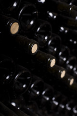 Close up of stacked up wine bottles in the old cellar