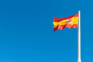 Spanish flag in the blue sky