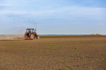 Farmer cultivating arable land before seeding