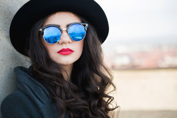 Fototapeta premium Portrait of young beautiful woman with long curly hair