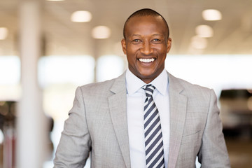 african car salesman in showroom