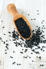 black cumin on wooden surface