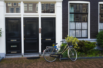 Tyoical street scene in Amsterdam or Holland with bicycle outside front of house