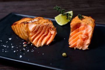 salmon steak served with potatoes and lime