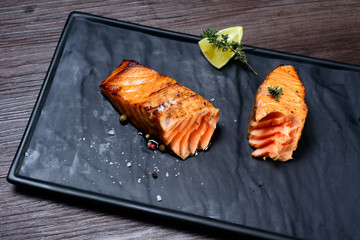 salmon steak served with potatoes and lime
