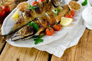 Mackerel baked with lemon, garlic and tomatoes