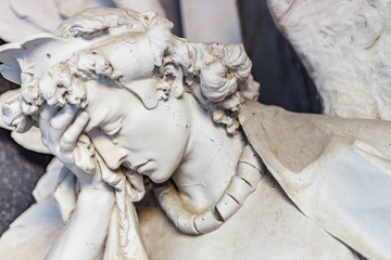 dusted statue of crying angel