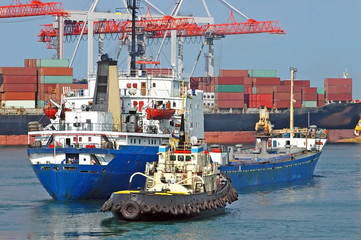 Tugboat assisting bulk cargo ship