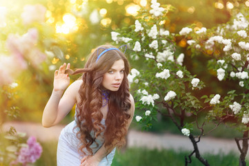 Sensual portrait of spring woman, beautiful face female enjoying cherry blossom