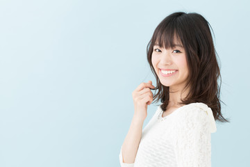 Fototapeta premium attractive asian woman on blue background