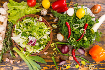 Overabundance of salad ingredients on table