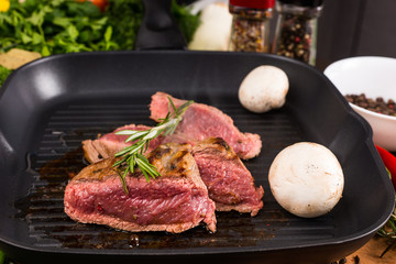 Rare Seasoned Beef Slices Sizzling in Hot Fry Pan