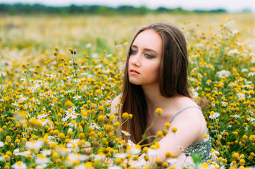 Portrait of young girl in chamomile field