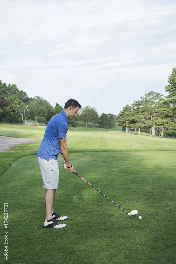 Poster male golfer practices swing