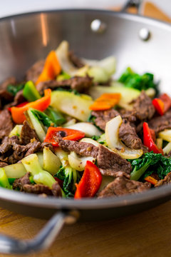Beef stir fry close up. Healthy vegetable & beef stir-fry. Made with flank steak, peppers, onions and bok choy stir fried in an asian wok.