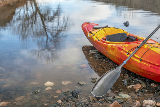 Kayak With Paddle On Lake Shore