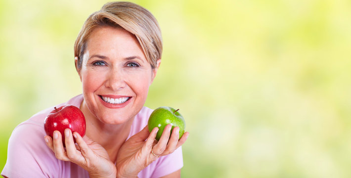 Mature Smiling Woman With Apple.