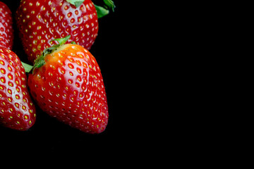 Half of strawberry isolated on black background
