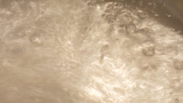 Water boiling in chrome pot close-up 4K 2160p UHD footage - Hot watter in the pot close-up 4K 3840X2160 UHD video